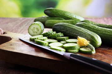 Fresh and sliced cucumbers. Sliced cucumbers on a cutting board. cucumbers for diet and healthy eating