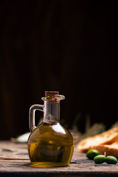 Olive oil with bread on a wooden table.