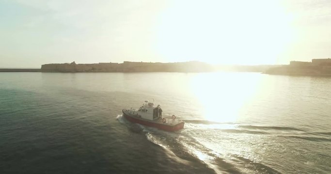 Aerial Shot over a boat between islands