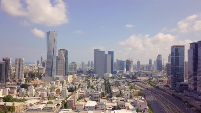 Aerial footage of Tel Aviv's skyline along the city's business district with ayalon freeway and skyscrapers.