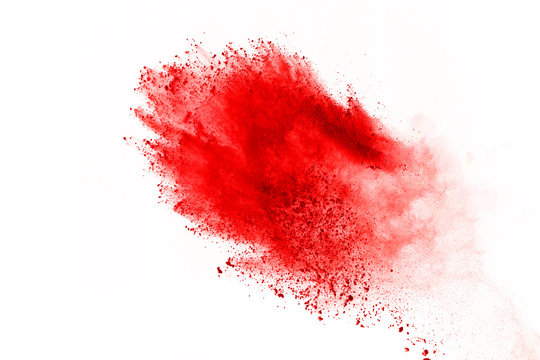 Abstract of red powder explosion on white background. Red powder splatted isolate. Colored cloud. Colored dust explode. Paint Holi.