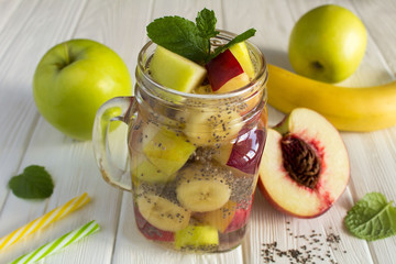 Detox water  with chia and  fruit on the  white wooden  background