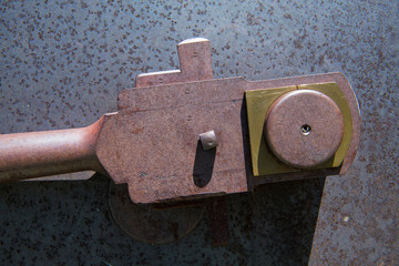 Close-up view of brass and steel connecting rod and wheel