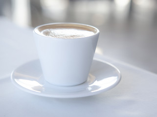 White cup of coffee on table