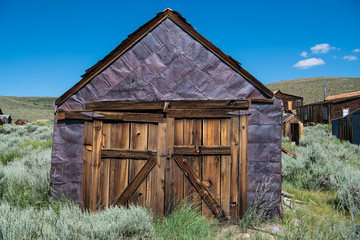 Abandoned, weathered, purple tin-clad building in the ghost town of Bodie, California
