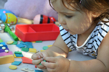 Happy preschool age children play with colorful plastic toy blocks. Creative kindergarten kids build a block tower. Educational toys for toddler or baby. Top view from above.