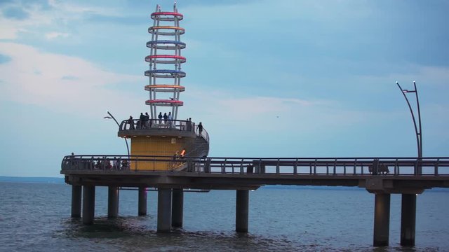 Close up of Burlington Pier during the evening with many people walking on it