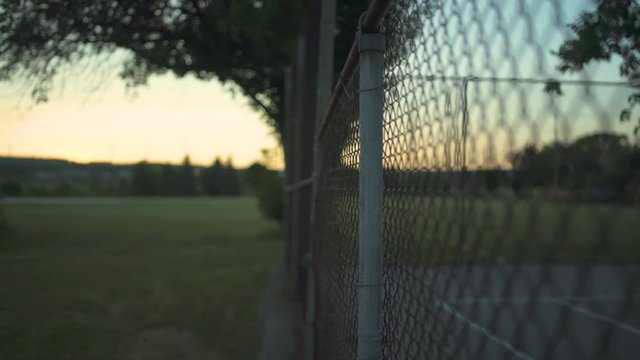 Fence in park at sunset