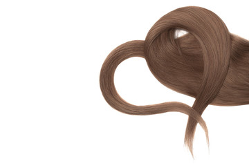 Brown hair in shape of heart on white background