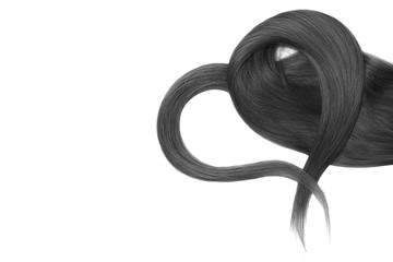Black hair in shape of heart on white background