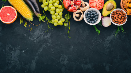 Food. Vegetables, fruits, nuts and berries. Healthy food. On the stone table. Top view. Free space for text.