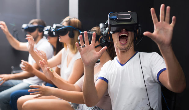 Excited  man experiencing with friends virtual reality