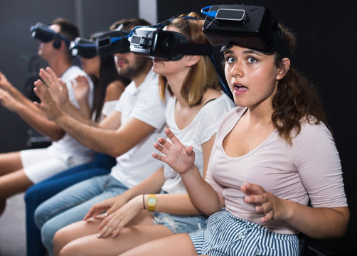 Portrait of frightened female after watching of exciting movie with VR glasses