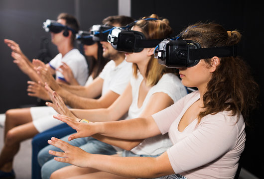 Woman watching exciting movie with VR glasses
