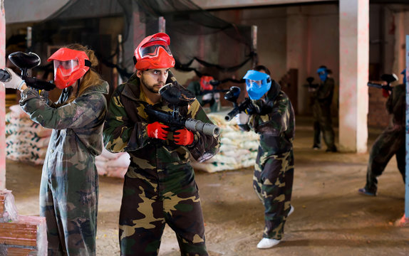 Players of red team are ready for attack on battlefield.