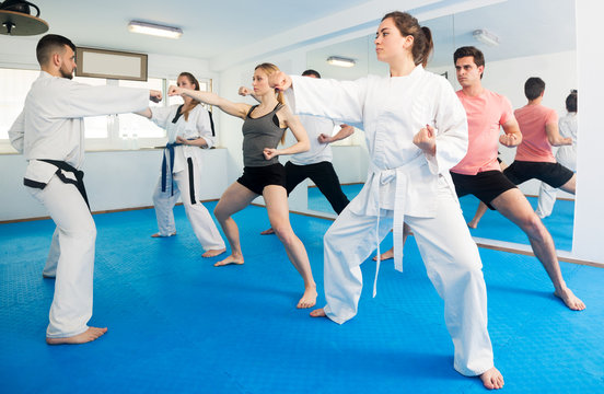 Adults trying new martial moves at karate class