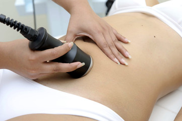 Cosmetology. Closeup Of Beautician Doing Laser Epilation Treatment On Beautiful Female Body, Removing Hair On Silky Skin. Woman Receiving Light Hair Removal Procedure In Beauty Salon.