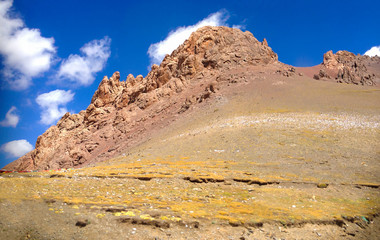 Beautiful Panoramic view of brown red rocky mountain ranges Landscape in arid climate rural Tibet, China.