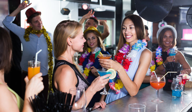 Women drinking cocktails in nightclub