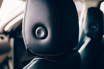 Detail of a car headrest in a leather upholstery
