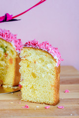 Sweet and appetizing cupcake with pink sprinkling on the table
