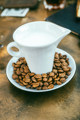 Coffee beans Close-up of coffee cup with roasted coffee beans on textures background View from top cappuccino Espresso dark