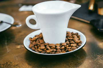 Coffee beans Close-up of coffee cup with roasted coffee beans on textures background View from top cappuccino Espresso dark