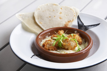 Fried fish patties in flambe