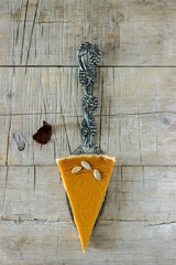 Traditional American pumpkin pie for Thanksgiving Day or Halloween on a wooden background. Rustic style.