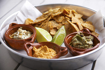 Home made nacho sampler with hummus, wacamole, and queso fresco
