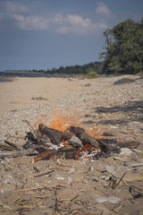 A bonfire burns in a camping i
