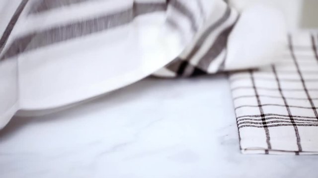 Folding Blck and white patterned paper towels on marble surface