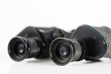 Old metal binoculars on a white table. Old military accessories for infantry.