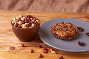 walnut peanut in clay bowl. peanuts for food textures. peanut harvest. fried peanuts. texture of the nuts and chocolate cookies on plate. selective focus