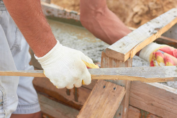 The builder pours the foundation.