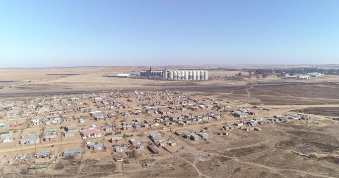 Large grain silo on the outskirts of African town aerial