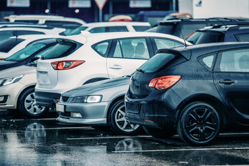 Fototapeta na wymiar Wet Used Cars on a Parking Lot During Rain