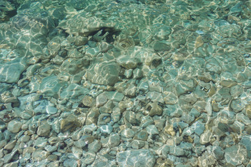 Naklejka na ściany i meble Clear sea, stone beach. Summer. Pattern. Background.