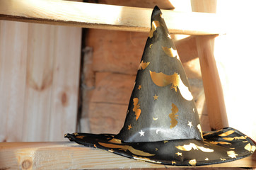 halloween witch hat on pumpkin wooden staircase lying on straw