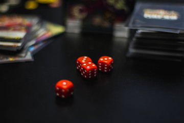 red dice on a black table, board game