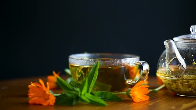 curative fresh hot tea with calendula flowers in a cup