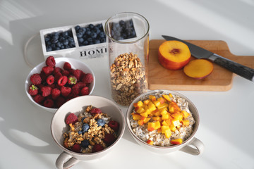 Breakfast set. Porridge with sliced apricot, berries and granola