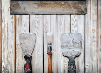 Spatulas with the remaining mortar. Gastarbeiter or guest worker concept. Handyman.