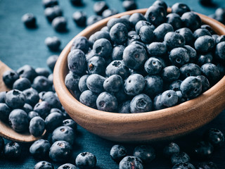 Blueberries with bowls and a spoon.