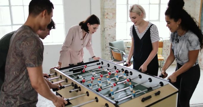 Friends playing table football