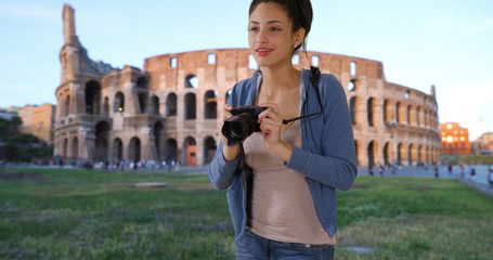Fototapeta premium Cute Latina tourist sightseeing in Rome takes picture near Roman coliseum