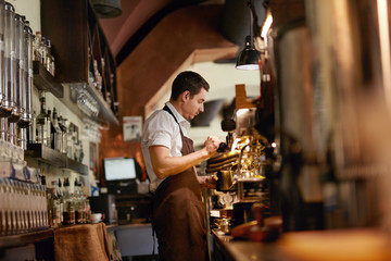 Barista Preparing Coffee In Coffee Shop