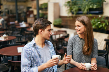 Couple Drinking Coffee In Cafe