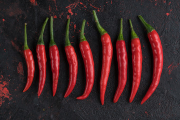 Red hot chili peppers on old wooden table with place for text