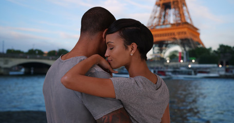 Traveling African-American couple enjoying view of Eiffel Tower together 